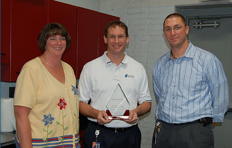 Jenny (Adams) Borsodi, Bob Adams, and Dan Adams accepting the Small Business of the Year award.